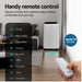 Air conditioner with remote control in a living room setting, highlighting remote operation features.