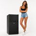 Woman standing next to a black caravan refrigerator
