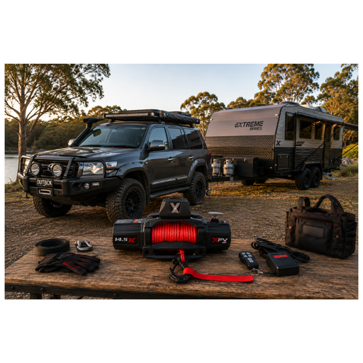 Black SUV with a trailer and outdoor equipment on a wooden table by a lake.