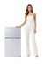 Woman in a white jumpsuit standing next to a 12v refrigerator 