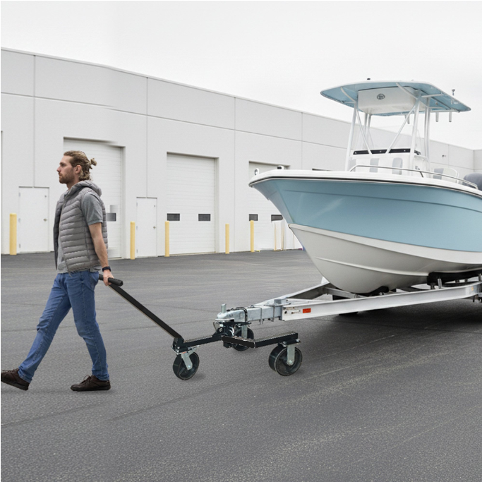 Man pulling a boat on a trailer with a building in the background