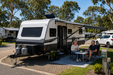 Roof vent on a caravan with two people sitting at a small table 