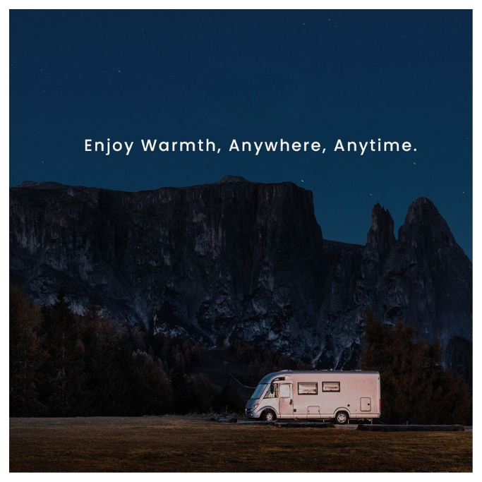 Pink RV parked in a field with mountains in the background and text 'Enjoy Warmth, Anywhere, Anytime.'
