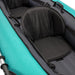 Black kayak seat pad on a teal kayak