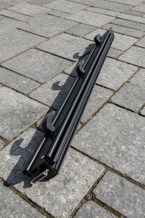 Black aluminium rod on a paved surface