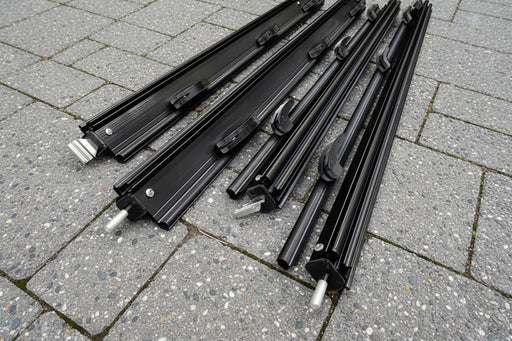 Set of components for awning flap eliminator kit