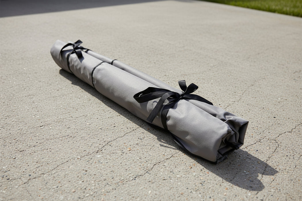 Gray rolled-up mat with black ribbons 