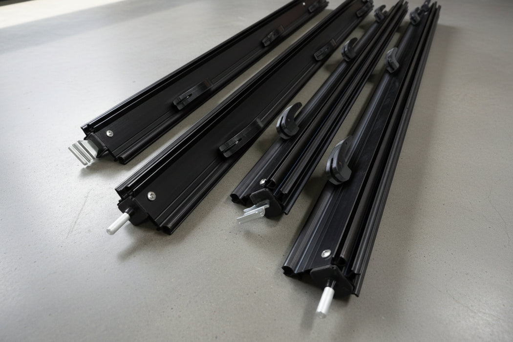 Black metal components for awning flap eliminator kit