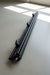Black metal component for awning flap eliminator kit