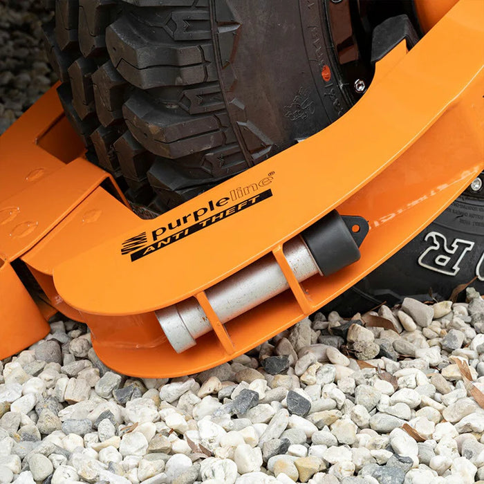 Close-up of an orange wheel clamp with 'Purpleline' branding on a gravel surface