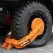 Close-up of a vehicle tire with an orange wheel clamp
